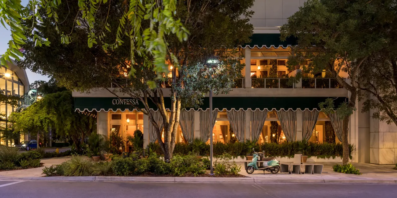 Contessa's green-awning facade at dusk