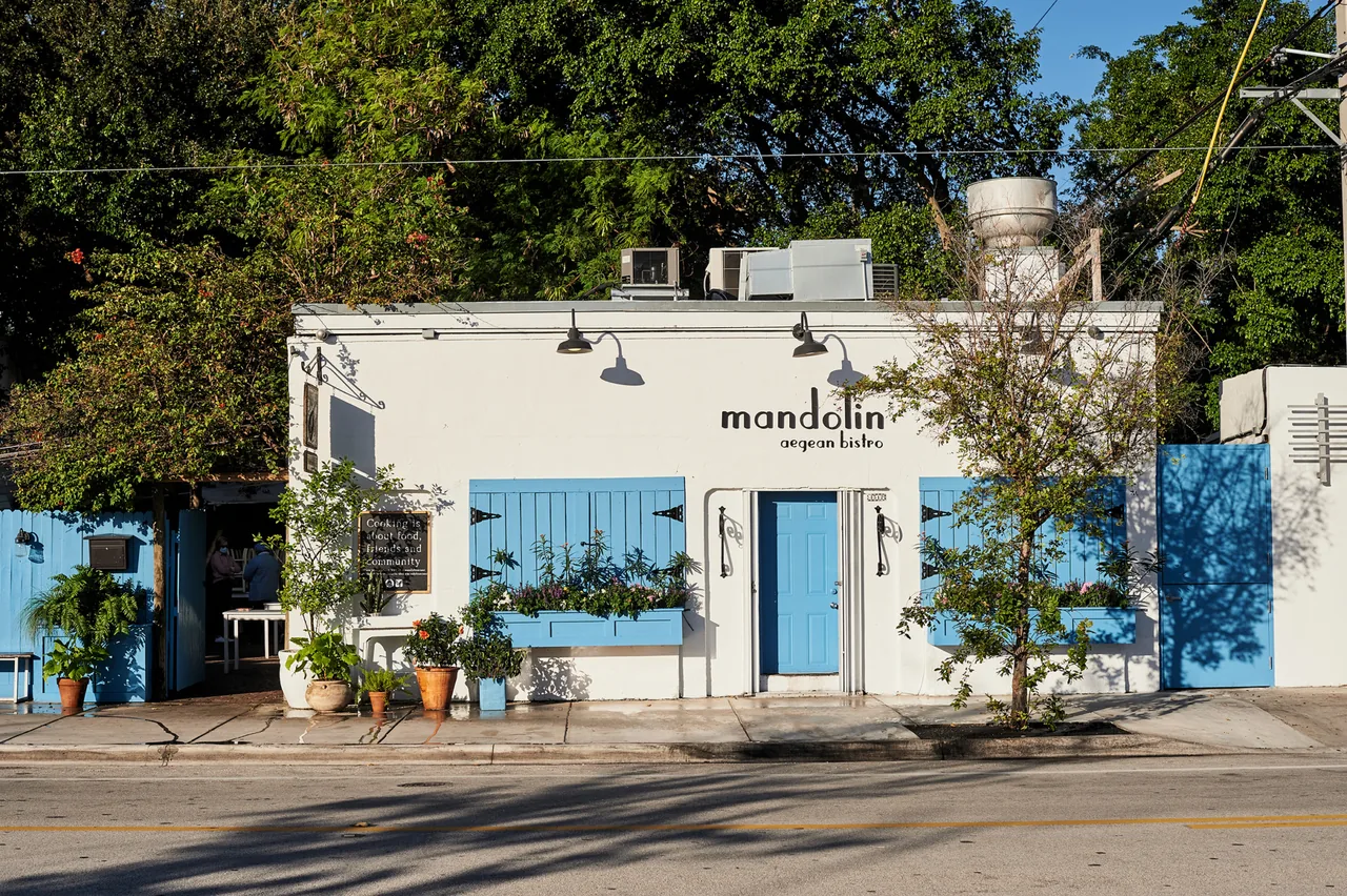 Mandolin Aegean Bistro's blue-doored white facade